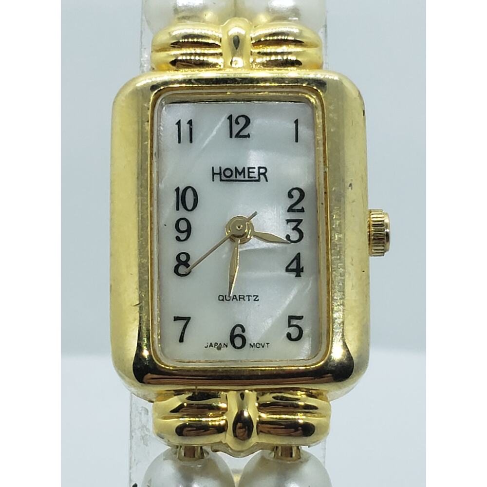 Homer women's dress watch. Pearled face with gold joining buckles and pearls